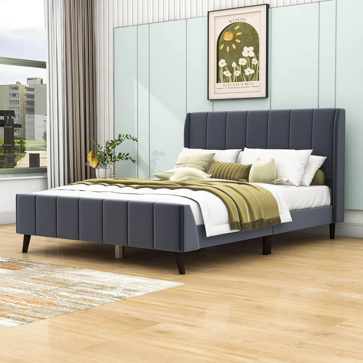Queen bed with grey upholstered frame in a bedroom