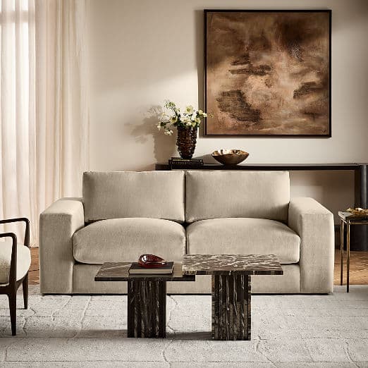 Modern taupe fabric two-seater sofa in a styled living room